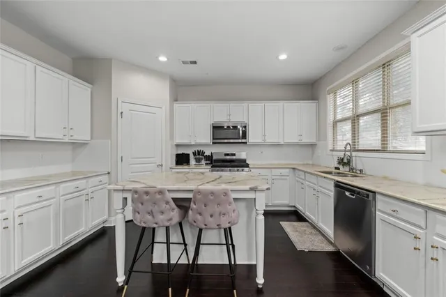 a kitchen with a stove a sink and a refrigerator