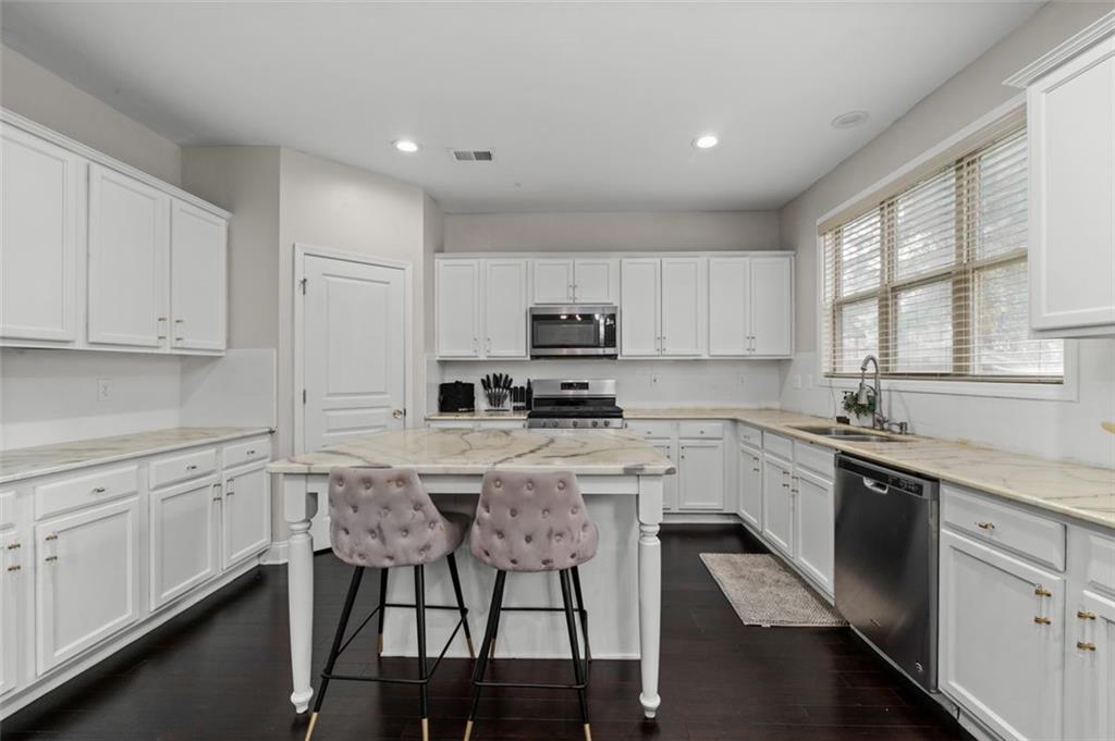 515 Lakeside View Fairburn, GA 30213 - Photo 18 of 43 a kitchen with granite countertop white cabinets and stainless steel appliances
