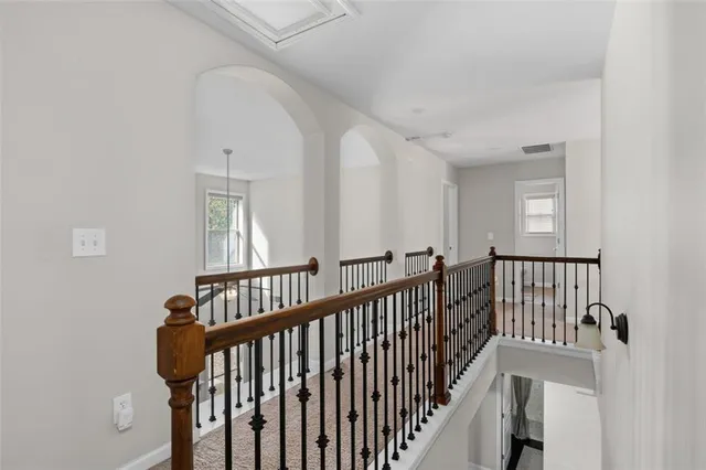 a bathroom with a sink a toilet and a large mirror