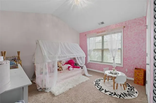 a bedroom with furniture and a mirror