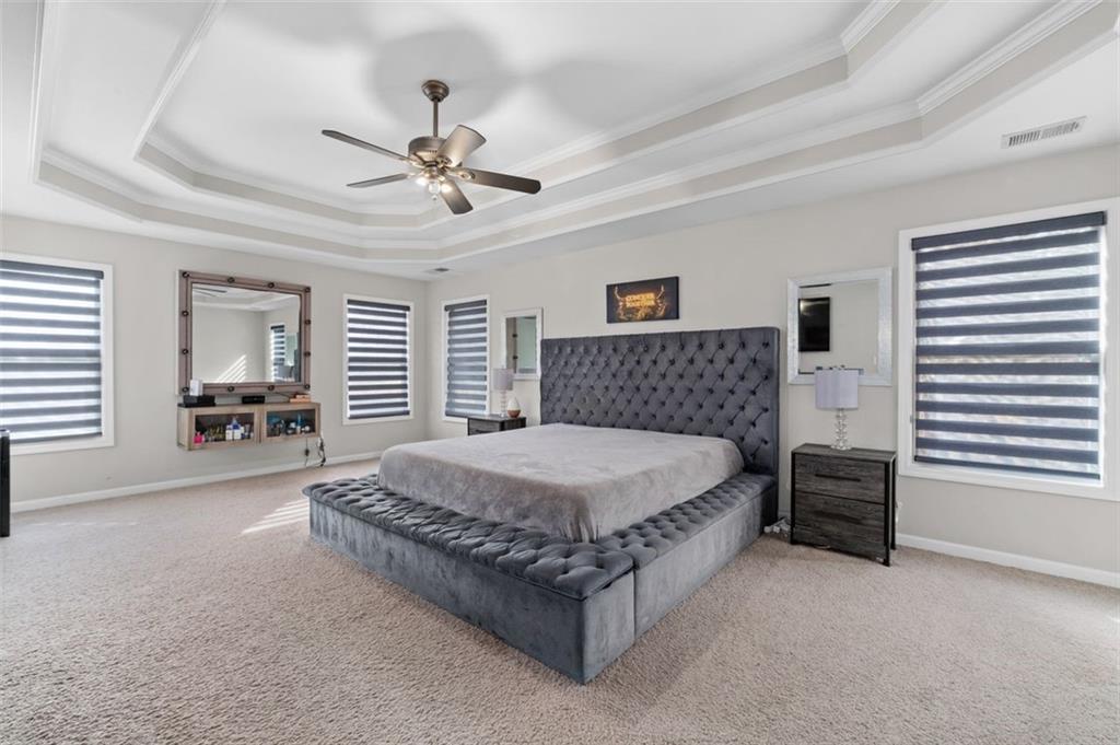 515 Lakeside View Fairburn, GA 30213 - Photo 26 of 43 a bedroom with a bed and a chandelier