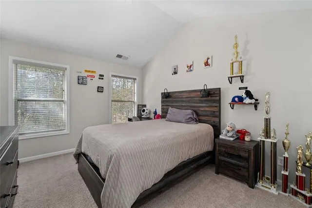 a bedroom with a bed and a desk