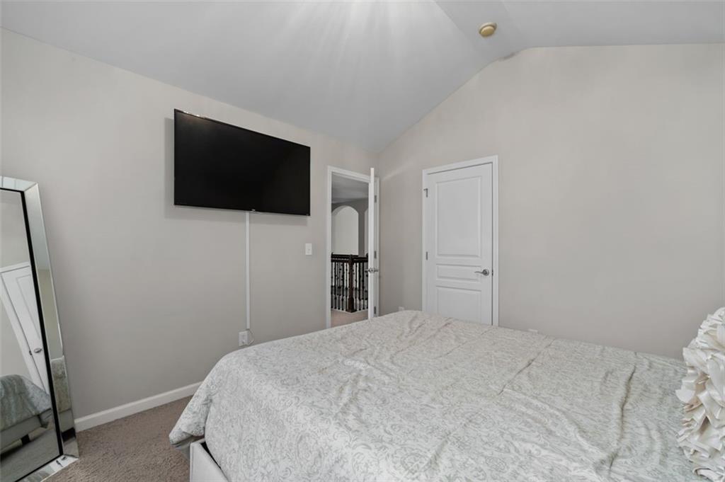 515 Lakeside View Fairburn, GA 30213 - Photo 35 of 43 a bedroom with a flat screen tv and a white bed