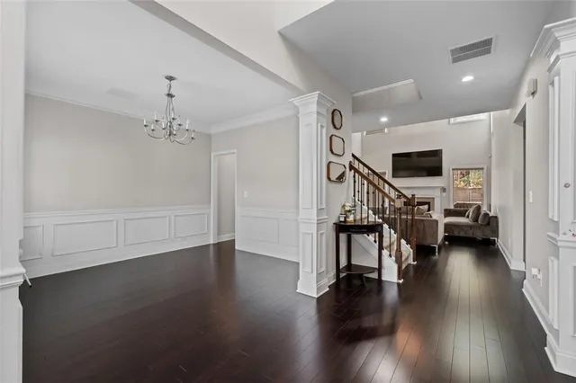 a view of a livingroom with furniture wooden floor and windows
