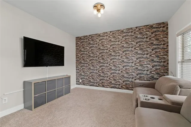 a living room with furniture and a floor to ceiling window