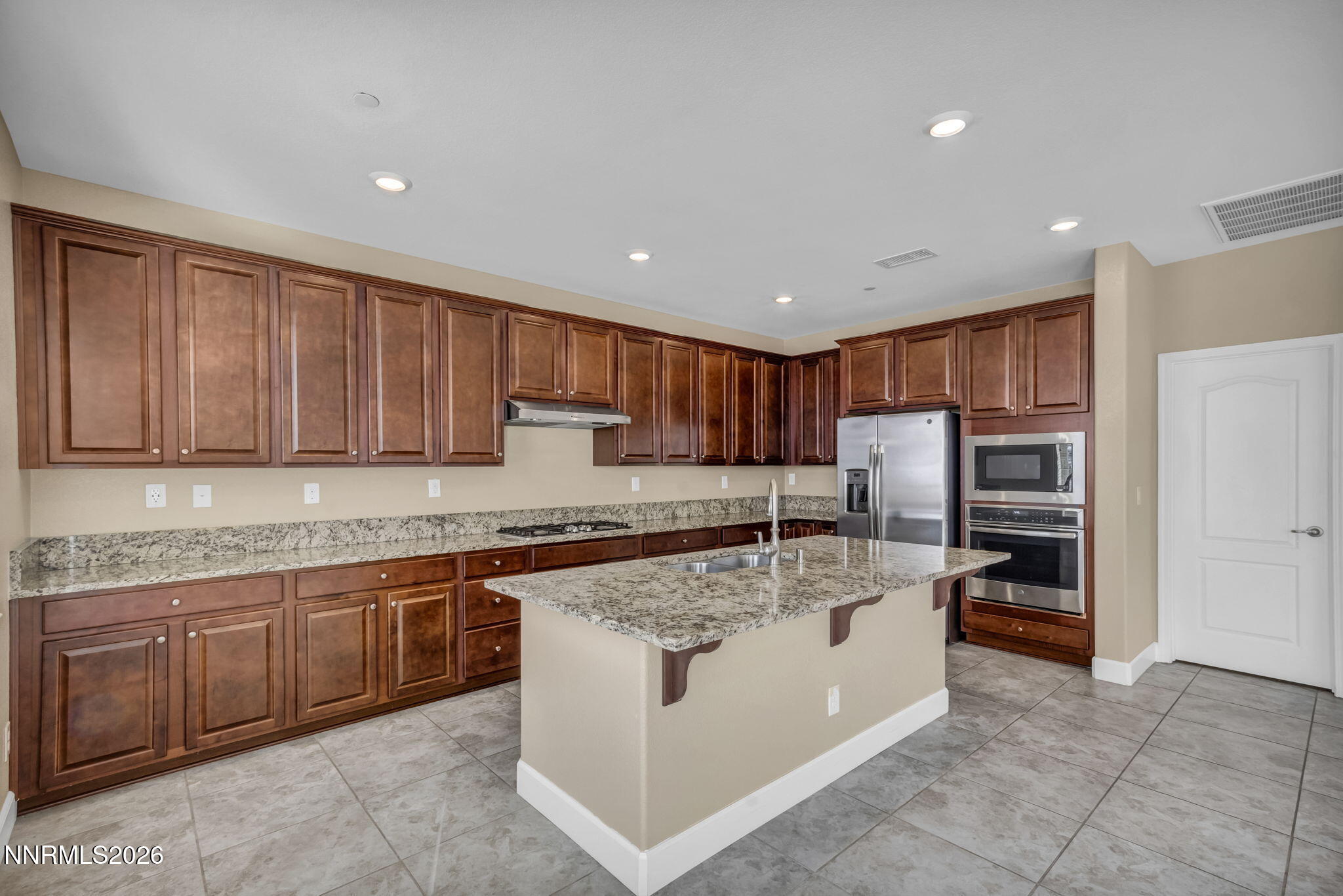 1725 Verdi Vista Court Reno, NV 89523 - Photo 3 of 19 a large kitchen with stainless steel appliances granite countertop a large counter top and a stove top oven