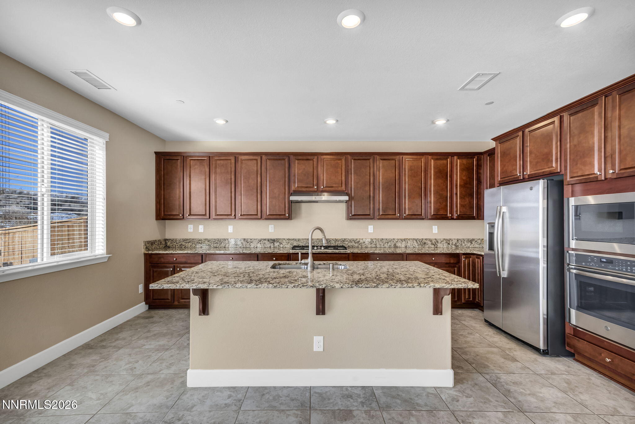 1725 Verdi Vista Court Reno, NV 89523 - Photo 5 of 19 a kitchen with kitchen island a counter top space cabinets stainless steel appliances and a window