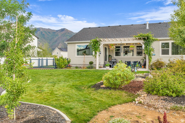 2454 West Jackson Street Mapleton, UT 84664 - Photo 44 of 63 Rear view of house featuring a covered patio, stucco siding, a mountain view, roof with shingles, and a gate