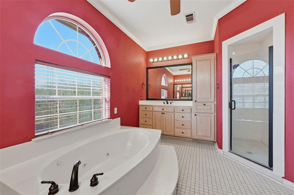 2210 Meadows Lane Sherman, TX 75092 - Photo 15 of 40 a spacious bathroom with a tub a double vanity sink and mirror