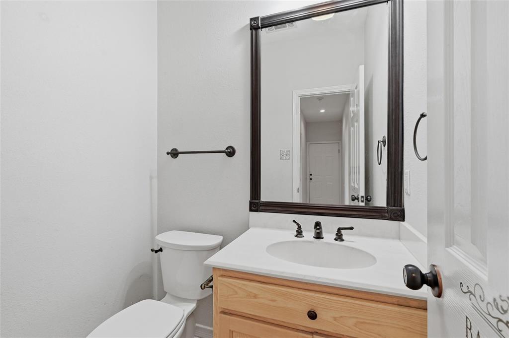 2210 Meadows Lane Sherman, TX 75092 - Photo 17 of 40 a bathroom with a sink and a mirror