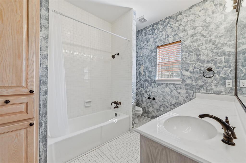 2210 Meadows Lane Sherman, TX 75092 - Photo 20 of 40 a bathroom with a sink and a bathtub