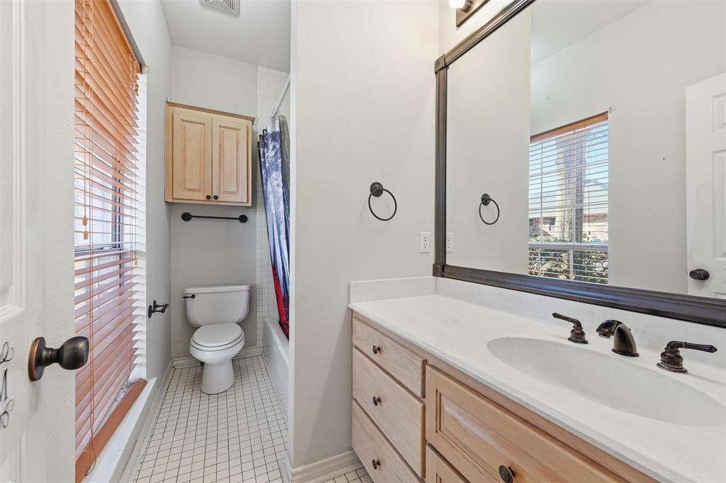 2210 Meadows Lane Sherman, TX 75092 - Photo 23 of 40 a bathroom with a sink toilet a mirror and shower
