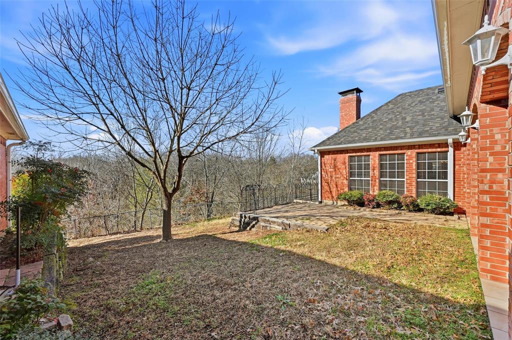 2210 Meadows Lane Sherman, TX 75092 - Photo 27 of 40 a front view of a house with a yard and garage