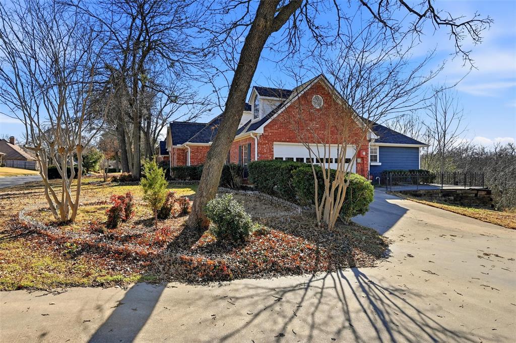 2210 Meadows Lane Sherman, TX 75092 - Photo 28 of 40 a front view of a house with garden