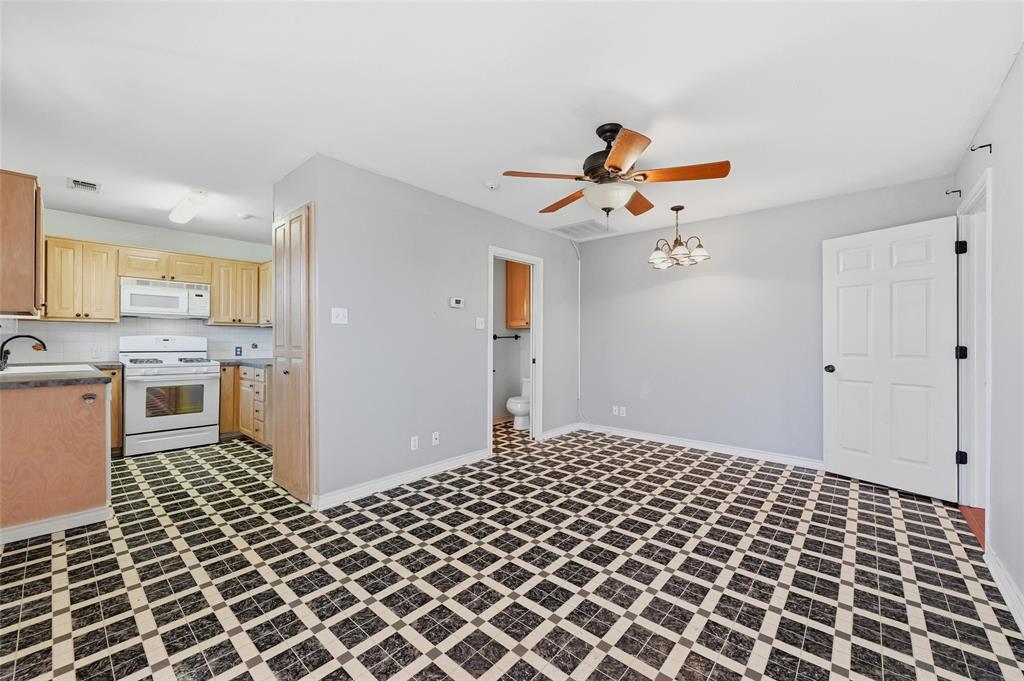 2210 Meadows Lane Sherman, TX 75092 - Photo 31 of 40 a bedroom with a bed and a chandelier