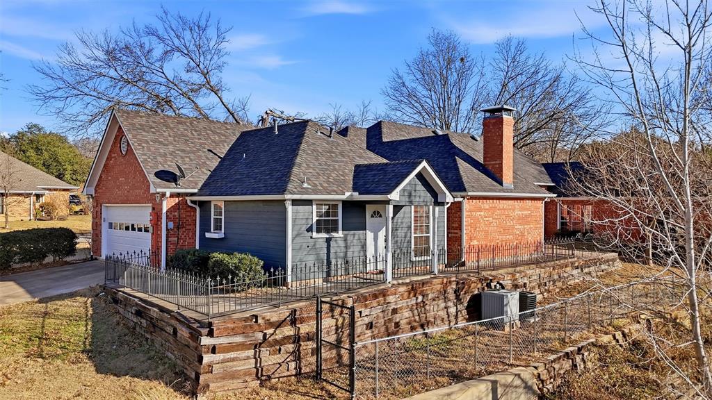 2210 Meadows Lane Sherman, TX 75092 - Photo 34 of 40 a front view of house with yard outdoor seating and yard