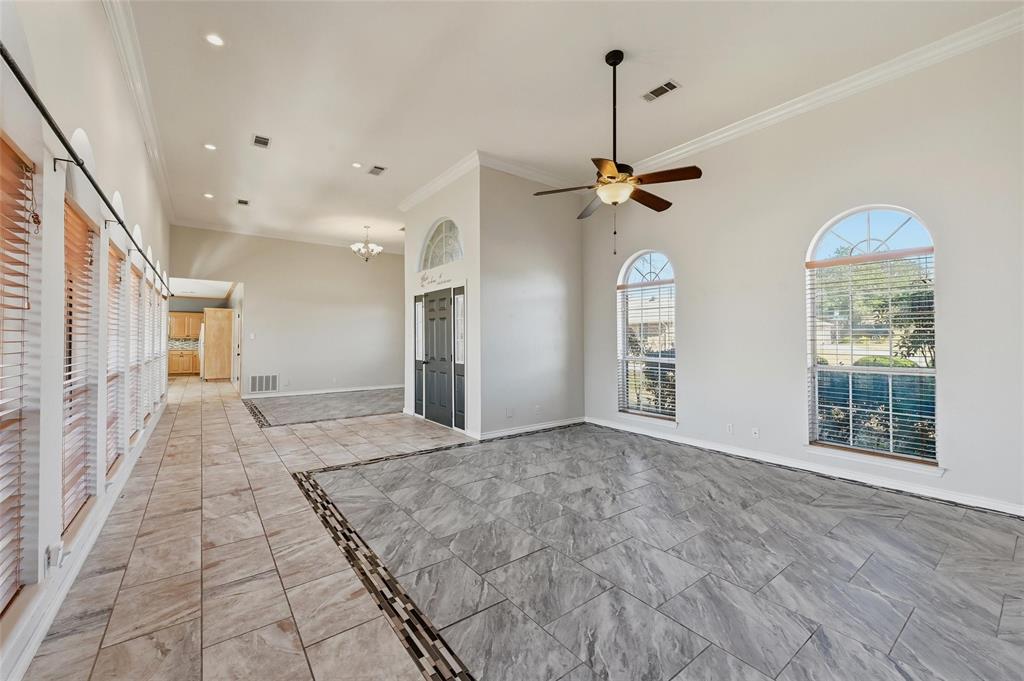 2210 Meadows Lane Sherman, TX 75092 - Photo 5 of 40 a view of a hallway with a chandelier fan and windows