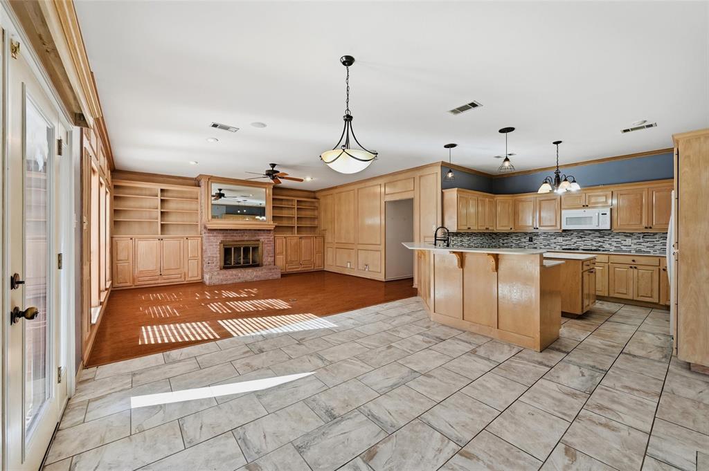 2210 Meadows Lane Sherman, TX 75092 - Photo 7 of 40 a kitchen with kitchen island granite countertop a stove a sink and a refrigerator