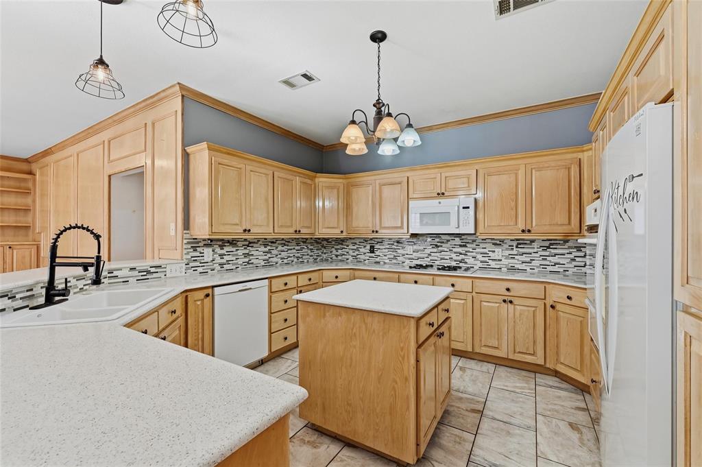 2210 Meadows Lane Sherman, TX 75092 - Photo 8 of 40 a kitchen with stainless steel appliances granite countertop a sink stove and refrigerator