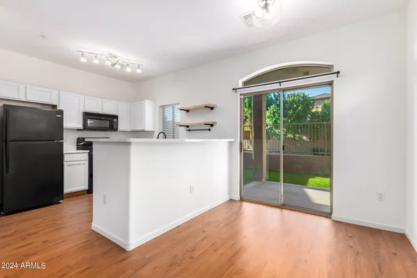 a kitchen with stainless steel appliances a refrigerator sink and white cabinets