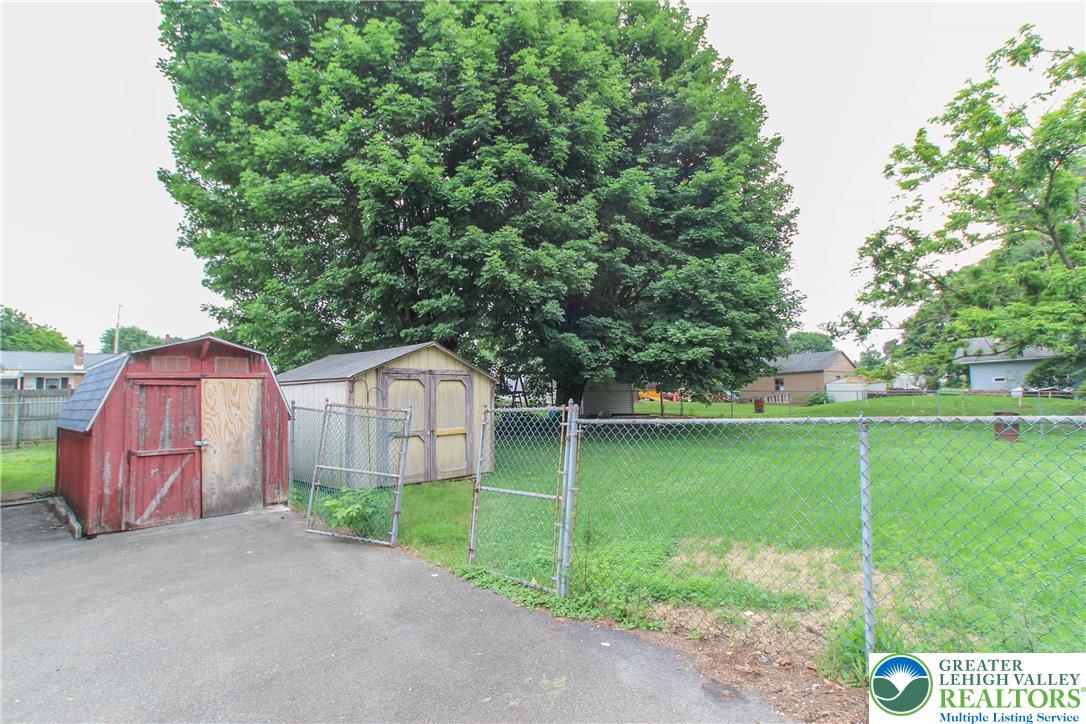 492 Filetown Road Nazareth, PA 18064 - Photo 7 of 30 A verdant backyard with two sheds provides ample outdoor storage and space for activities.