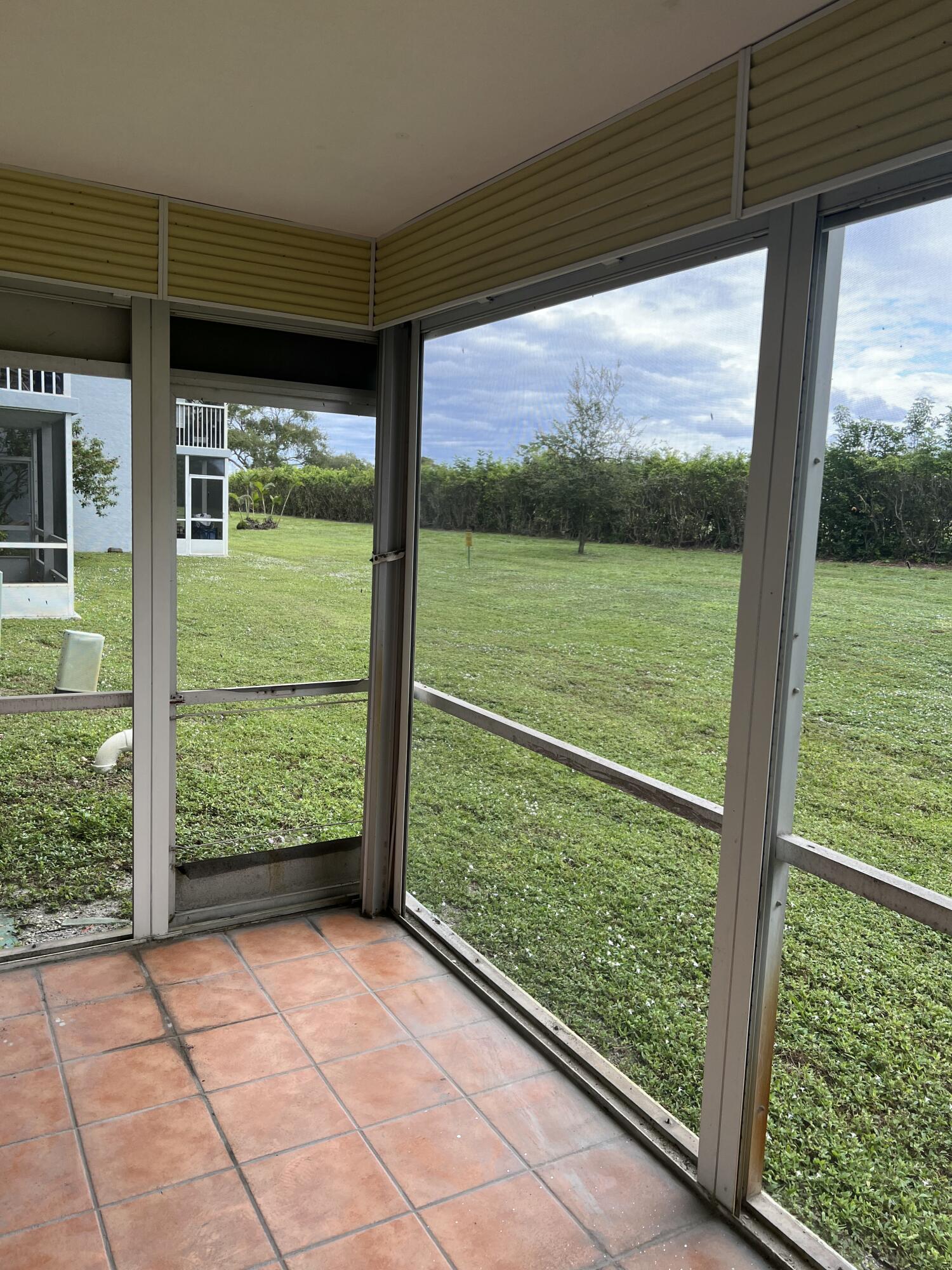 5500 Northwest 2nd Avenue, Unit 121 Boca Raton, FL 33487 - Photo 19 of 28 a view of backyard with large window and wooden floor