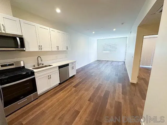 a view of a kitchen with wooden floor