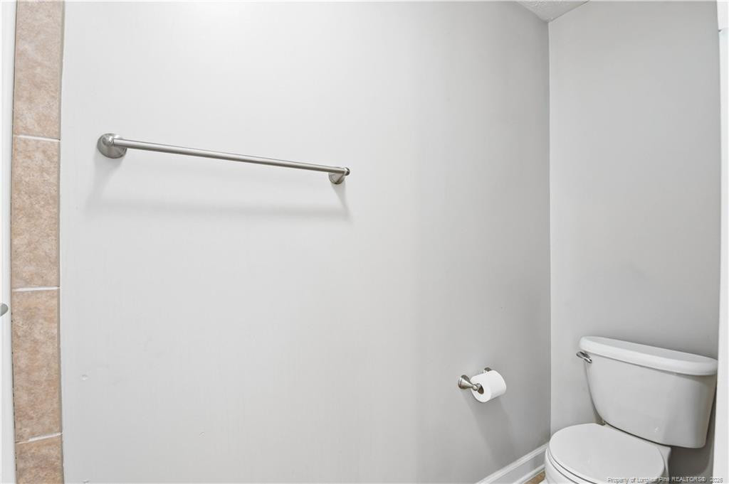 212 Lennox Loop Raeford, NC 28376 - Photo 30 of 47 a white toilet sitting next to a shower