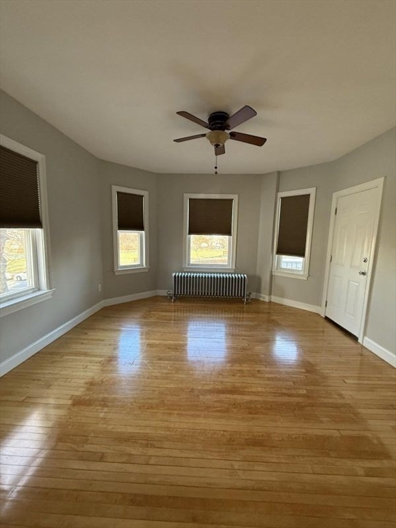 517 President Fall River, Unit 1 Fall River, MA 02720 - Photo 4 of 13 a view of empty room with wooden floor and fan