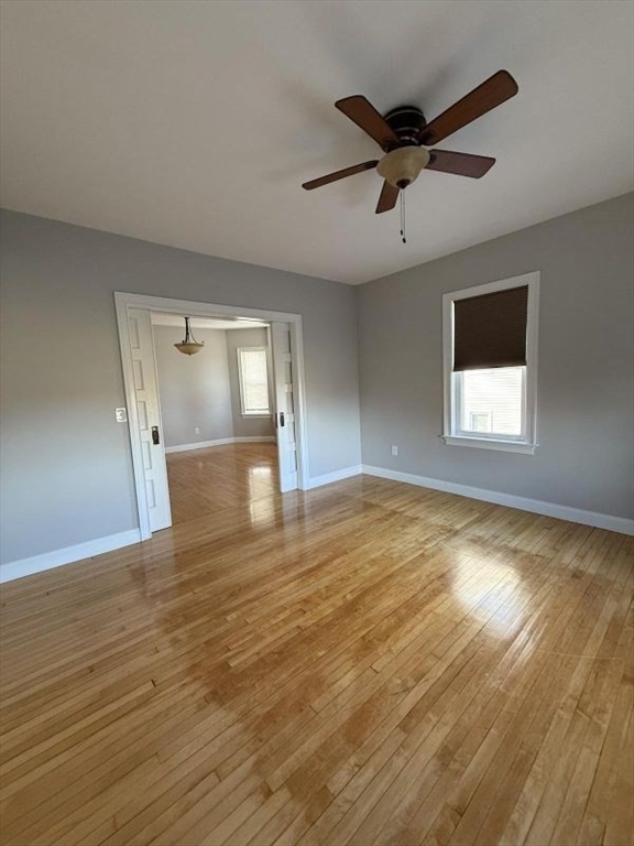 517 President Fall River, Unit 1 Fall River, MA 02720 - Photo 7 of 13 a view of empty room with wooden floor and fan