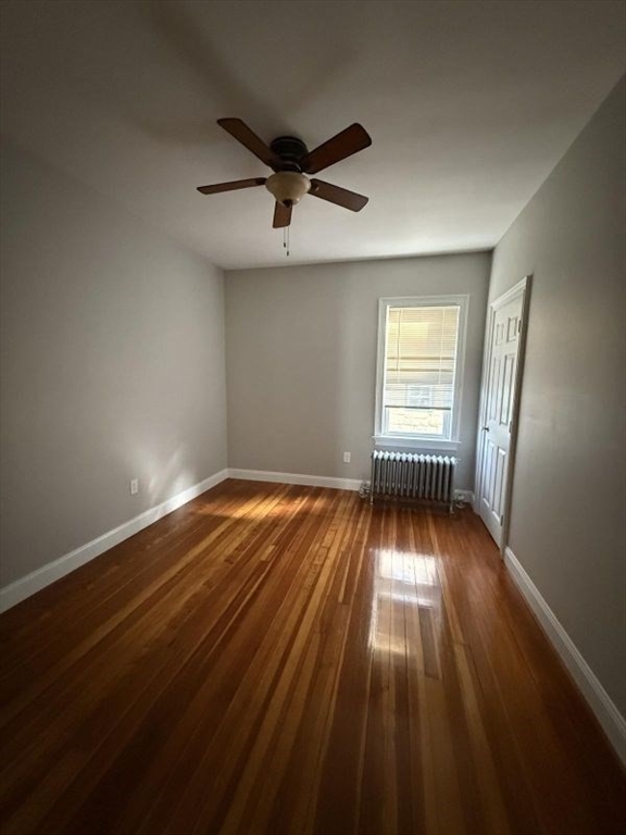 517 President Fall River, Unit 1 Fall River, MA 02720 - Photo 9 of 13 a view of empty room with wooden floor and fan