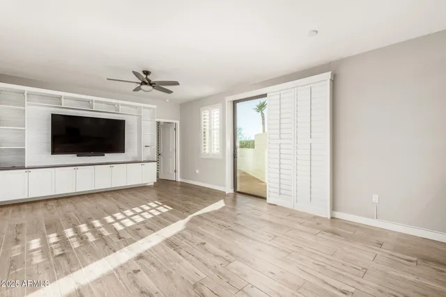 a living room with a flat screen tv and a fireplace