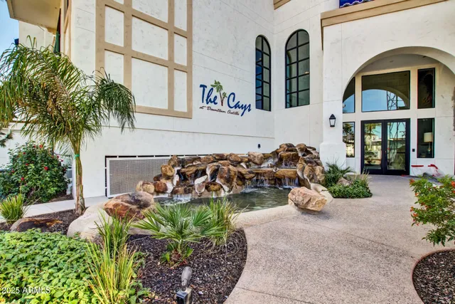 a view of a chairs and table in patio with a small pool