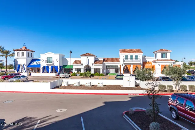 a living room with furniture a chandelier and entryway