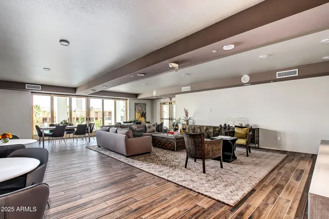 a room with stainless steel appliances kitchen island a table and chairs in it