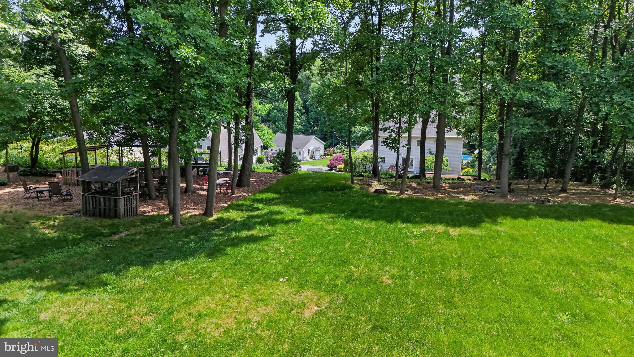 257 Hill Road New Holland, PA 17557 - Photo 19 of 94 Serene backyard oasis in lush greenery.