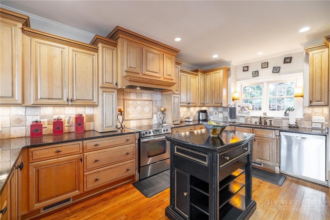 50 Mitchell River Ridge Thurmond, NC 28683 - Photo 12 of 43 a kitchen with stainless steel appliances granite countertop a stove a sink dishwasher and cabinets with wooden floor