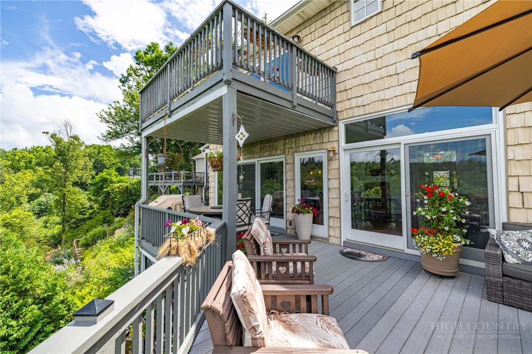 50 Mitchell River Ridge Thurmond, NC 28683 - Photo 17 of 43 a view of a chair and tables in the balcony