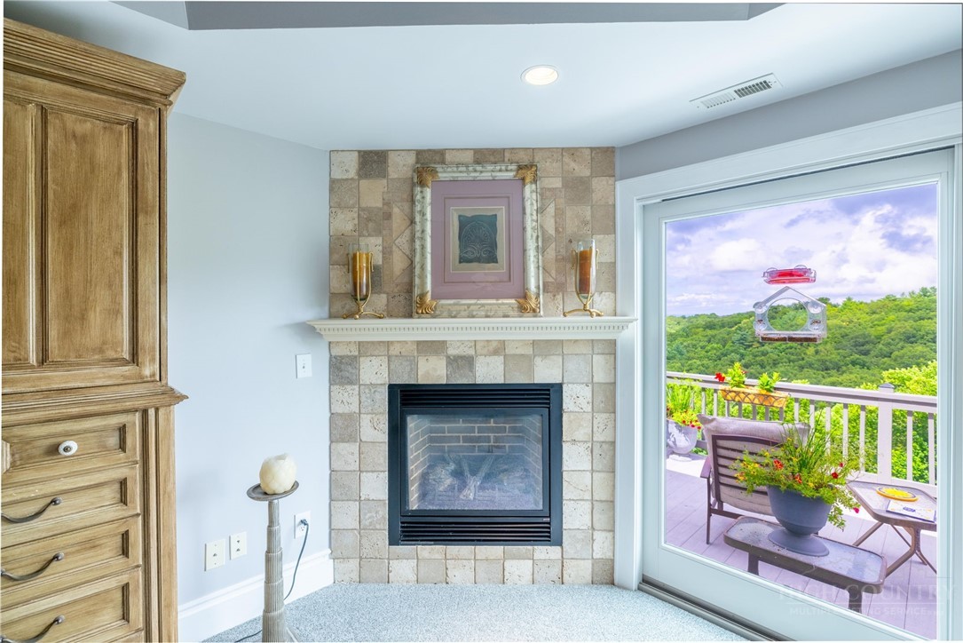 50 Mitchell River Ridge Thurmond, NC 28683 - Photo 23 of 43 a living room with a fireplace and a floor to ceiling window