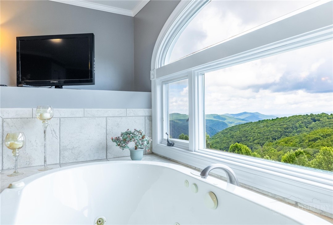 50 Mitchell River Ridge Thurmond, NC 28683 - Photo 25 of 43 a view of a living room with a flat screen tv and floor to ceiling window