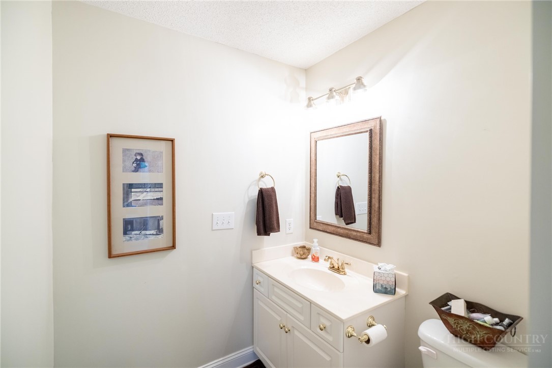50 Mitchell River Ridge Thurmond, NC 28683 - Photo 33 of 43 a bathroom with a toilet a sink and mirror