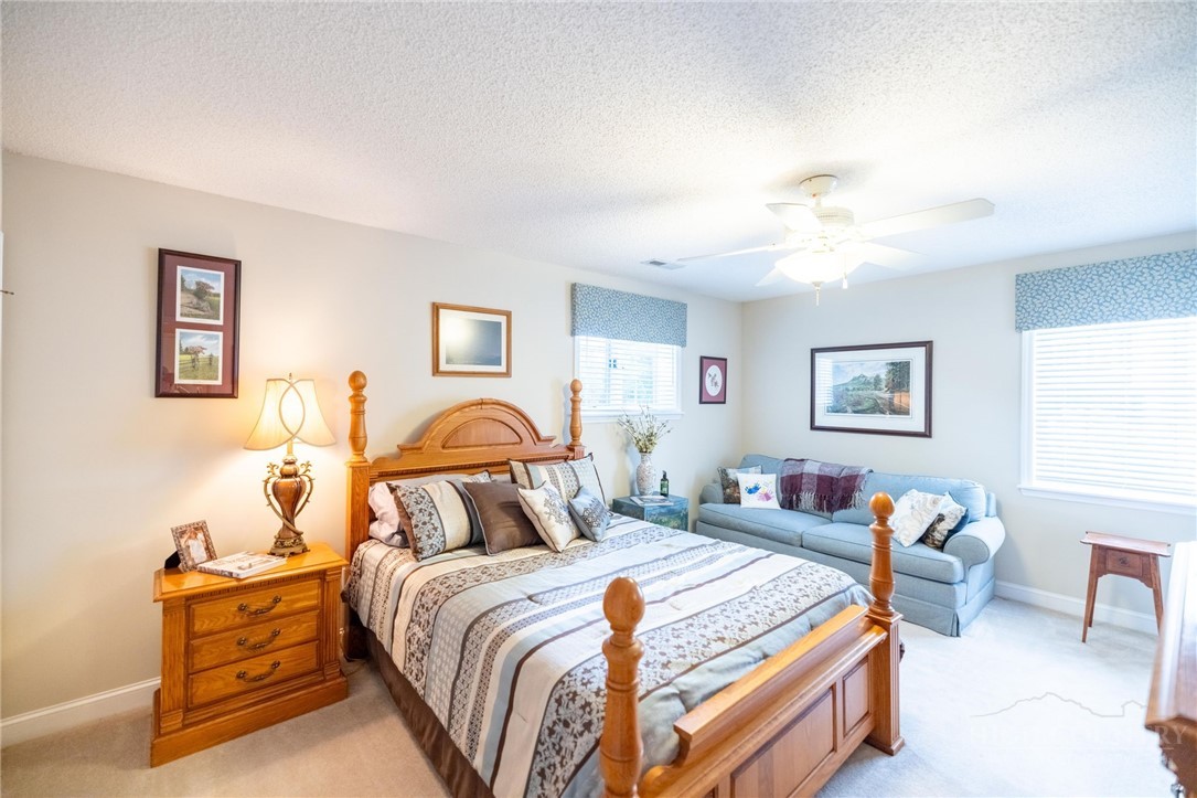 50 Mitchell River Ridge Thurmond, NC 28683 - Photo 34 of 43 a bedroom with a bed and a chandelier