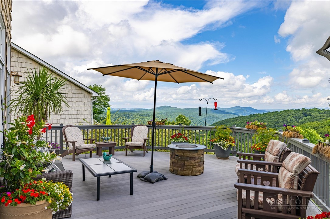 50 Mitchell River Ridge Thurmond, NC 28683 - Photo 4 of 43 a view of a chairs and table in patio with a garden