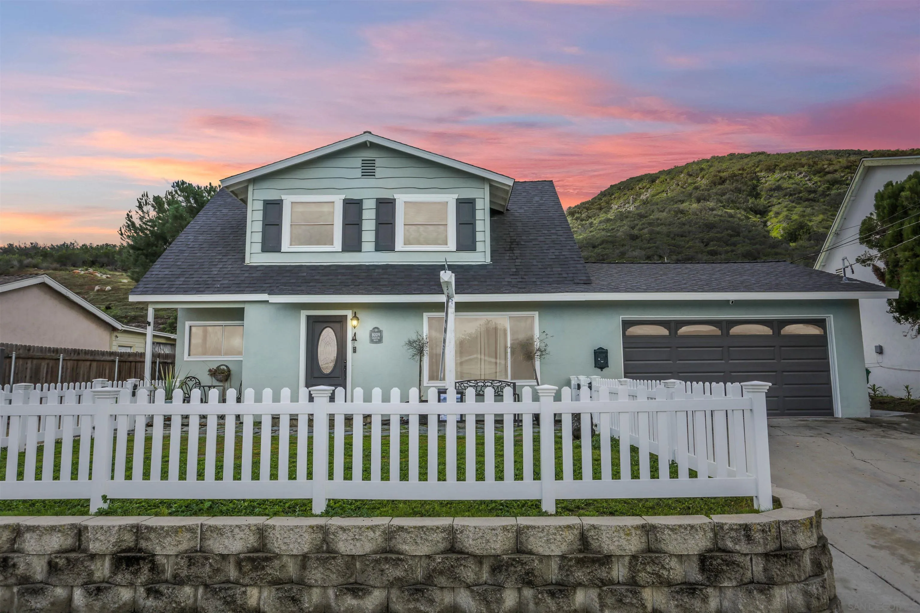 a front view of a house with a garden