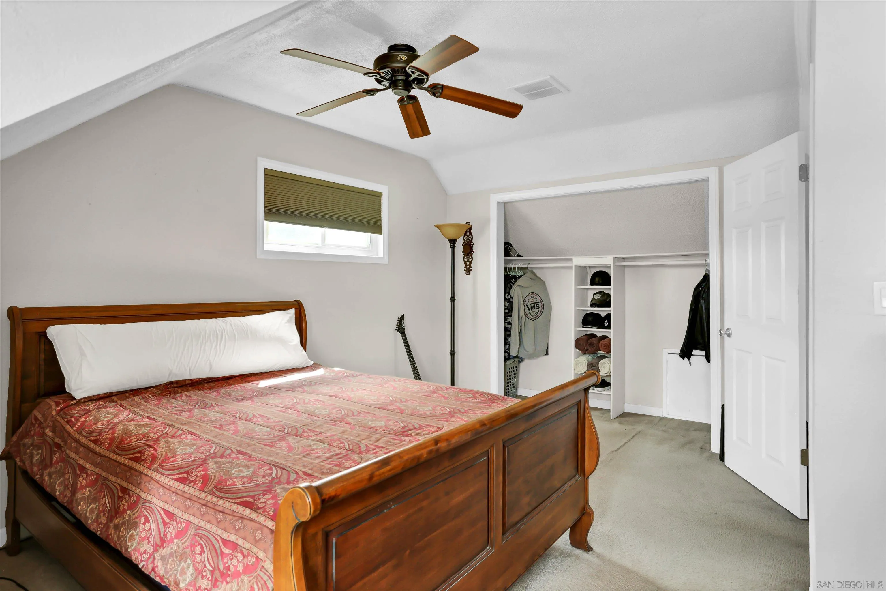 8009 Shantung Drive Santee, CA 92071 - Photo 13 of 39 a bedroom with a bed a dresser and a chandelier