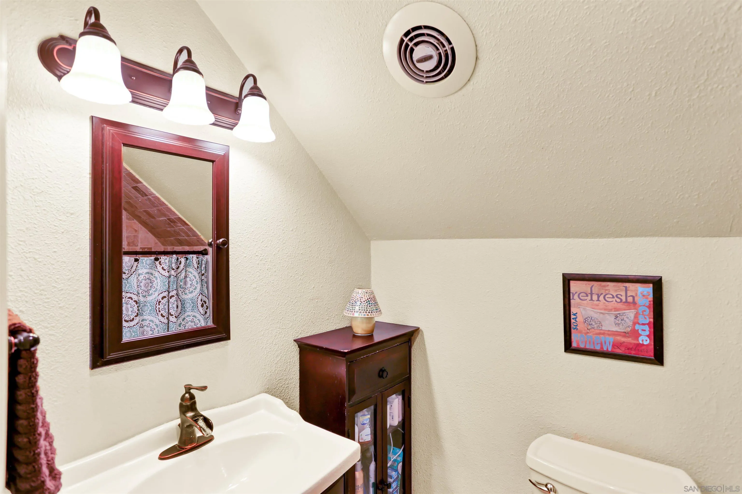 8009 Shantung Drive Santee, CA 92071 - Photo 15 of 39 a bathroom with a toilet a sink and a mirror