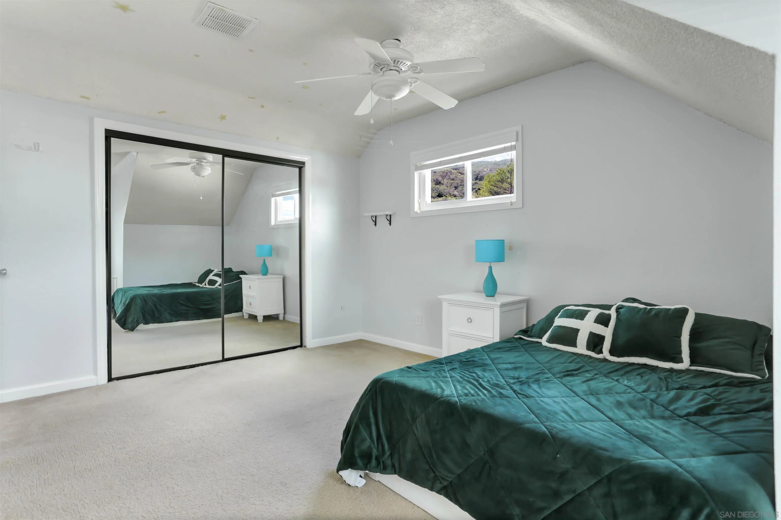 8009 Shantung Drive Santee, CA 92071 - Photo 17 of 39 a bedroom with a bed and a mirror