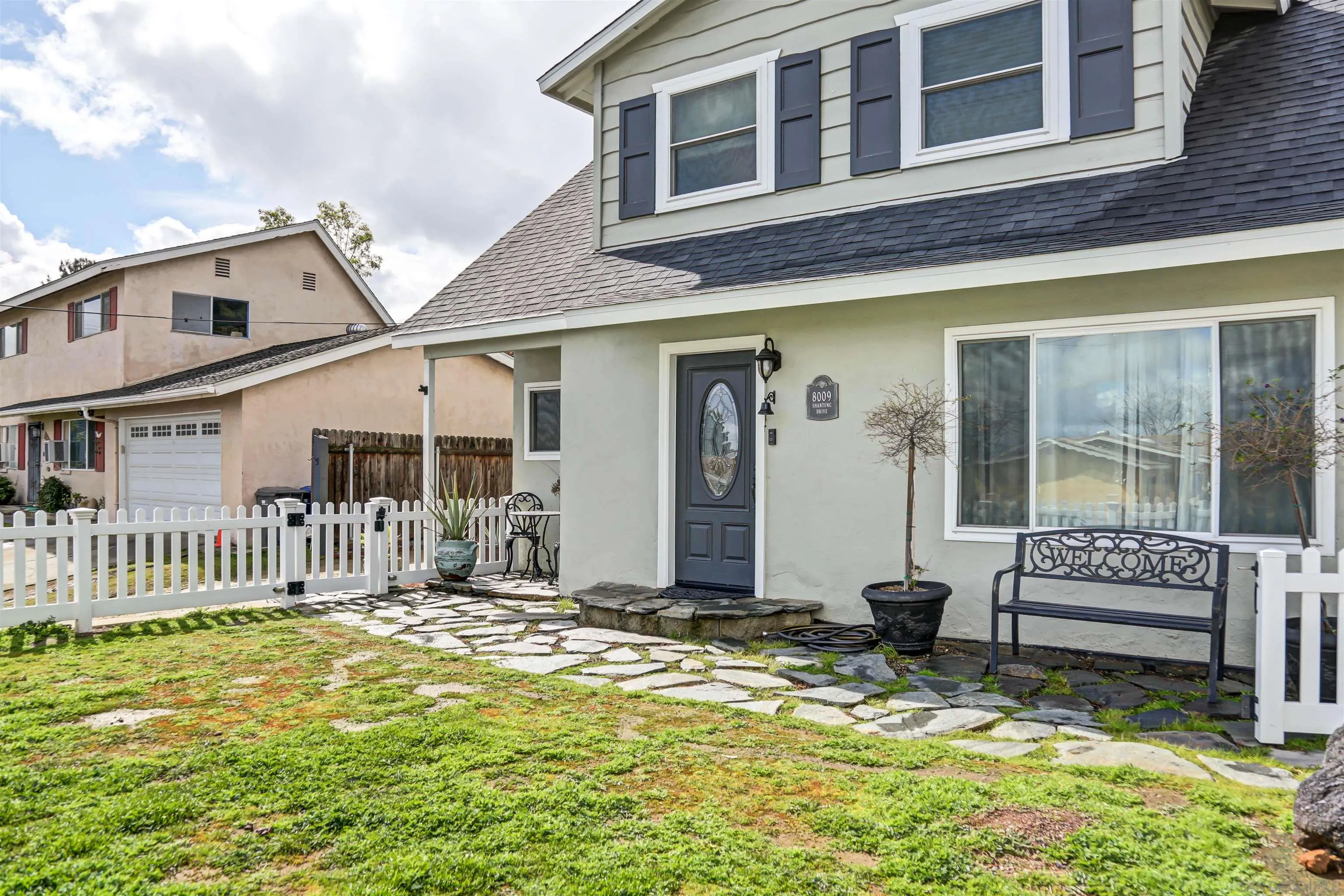 8009 Shantung Drive Santee, CA 92071 - Photo 30 of 39 a backyard of a house with barbeque oven table and chairs