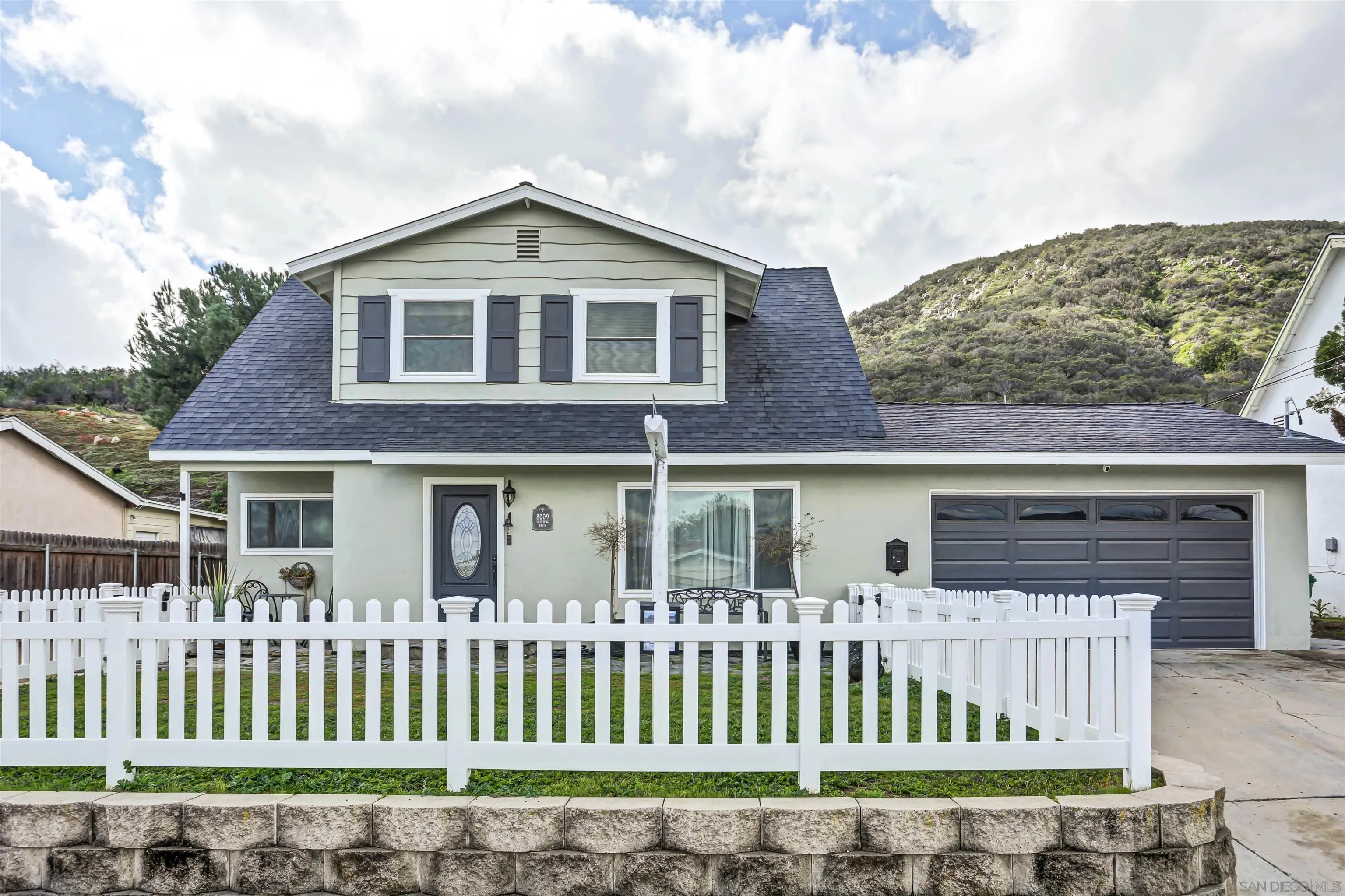 8009 Shantung Drive Santee, CA 92071 - Photo 34 of 39 a front view of a house with a garden