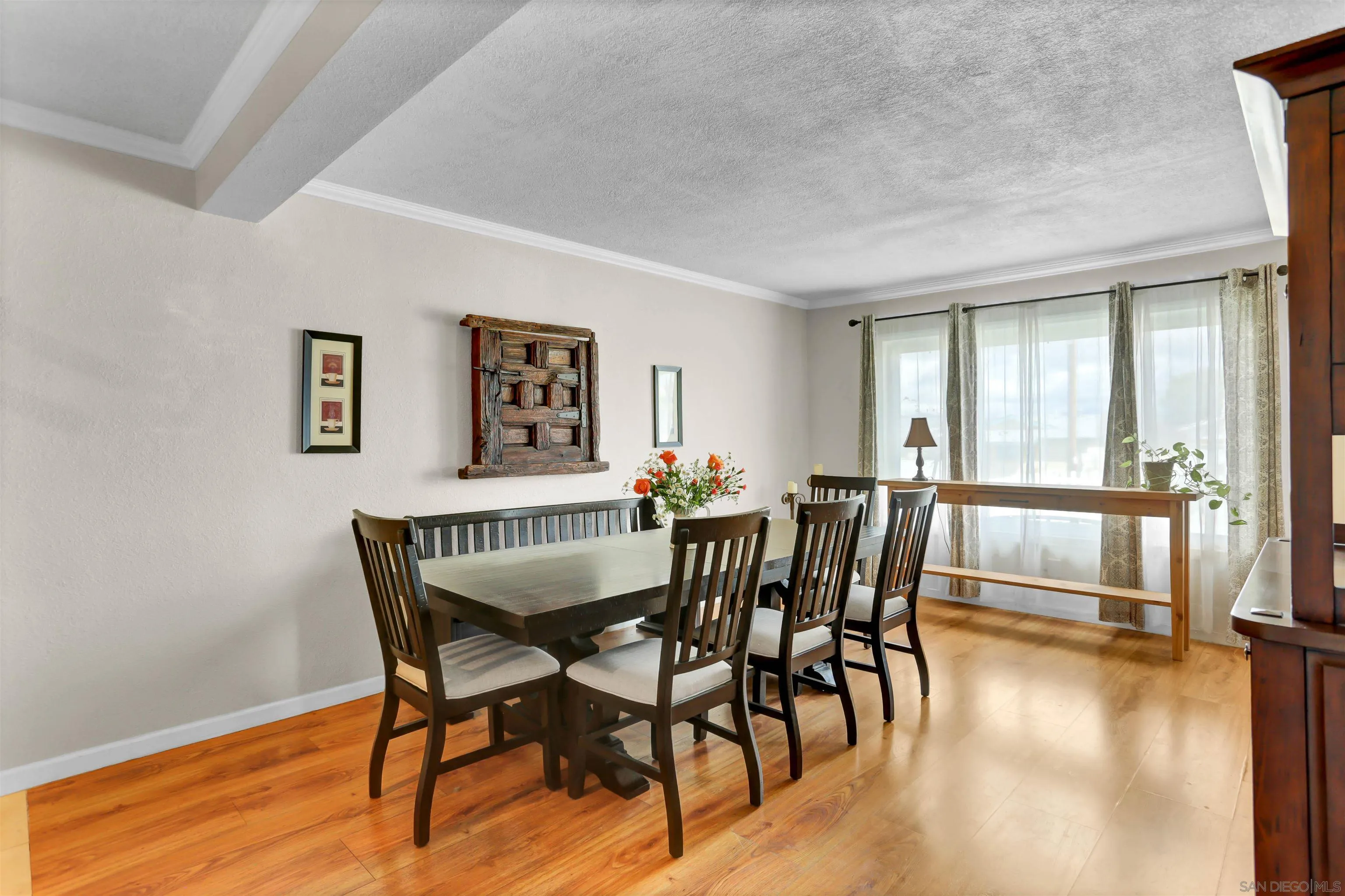 8009 Shantung Drive Santee, CA 92071 - Photo 4 of 39 a view of a dining room with furniture window and wooden floor